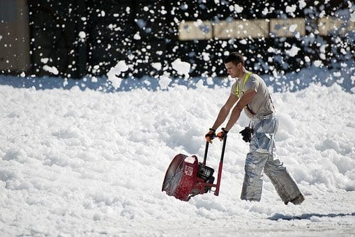 Snow thrower clearing snow