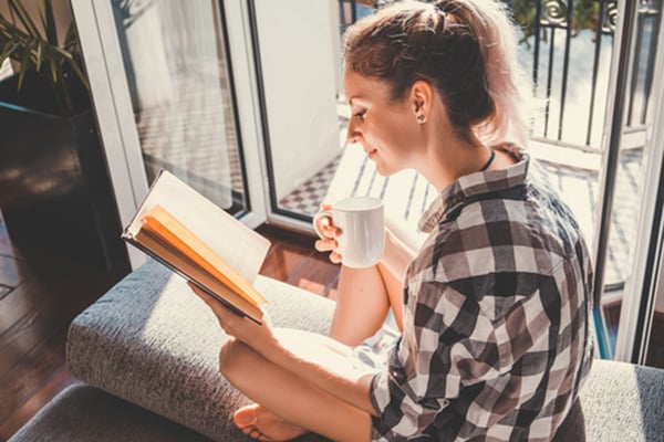 women sitting in natural light reading