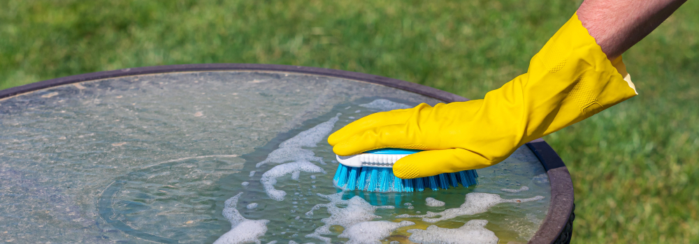 Cleaning a patio table with a scrubber