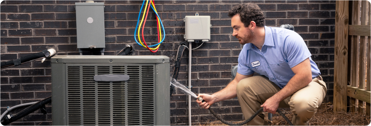 technician cleaning AC