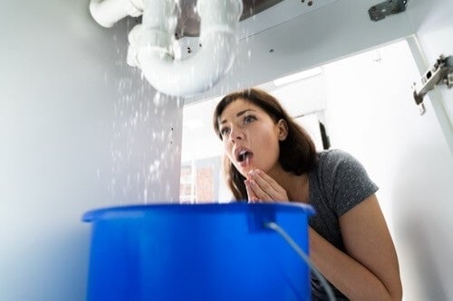 woman looking under sink