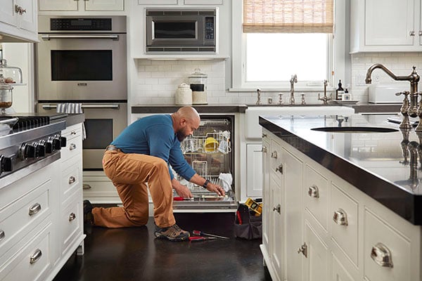 repair man in kitchen 