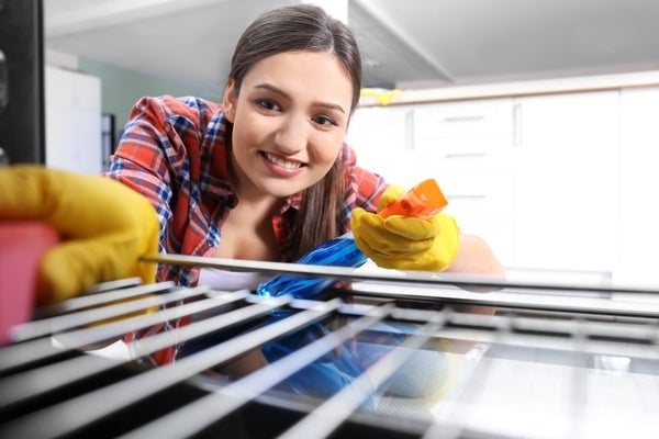 Person cleaning an oven rack.