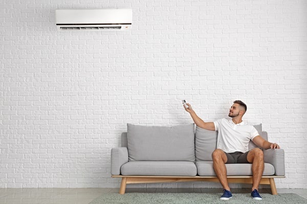 Man sitting next to AC unit