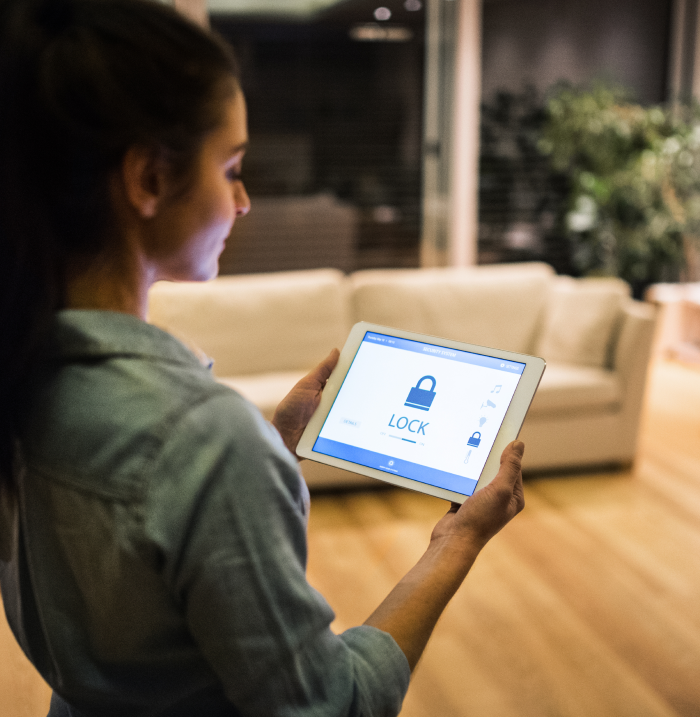 A woman looking at locked tablet device.