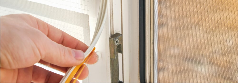 Person fixing drafty window.