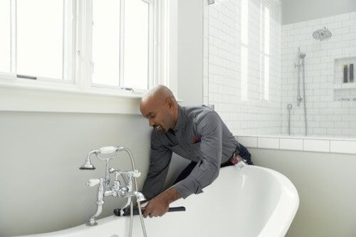 man fixing bathtub