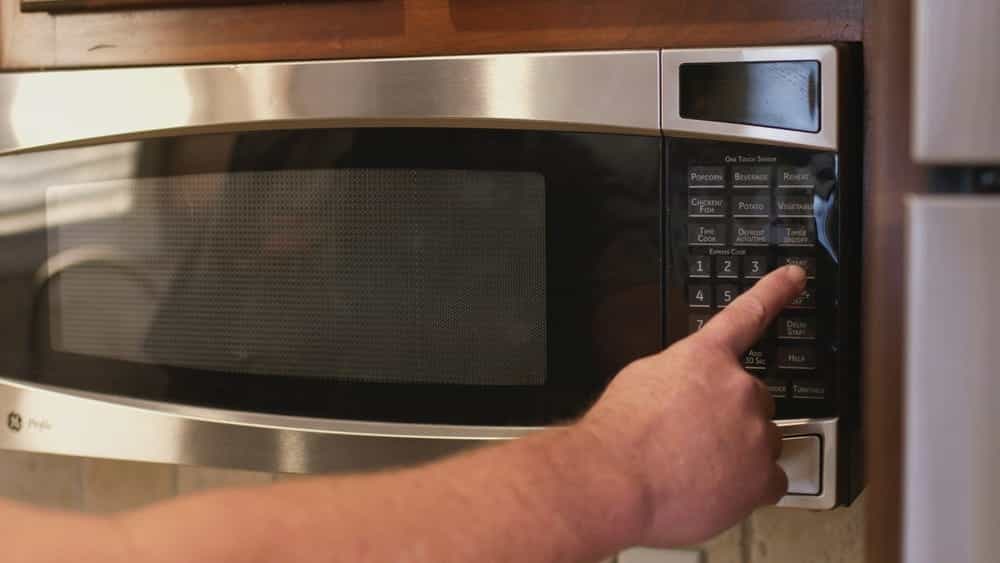 pressing Start button on microwave