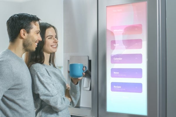 couple looking at smart fridge display